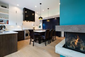 kitchen with unique turquoise and concrete fireplace