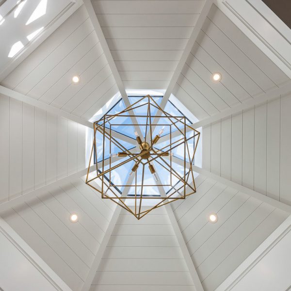 chandelier hung under a skylight in a dining room turret