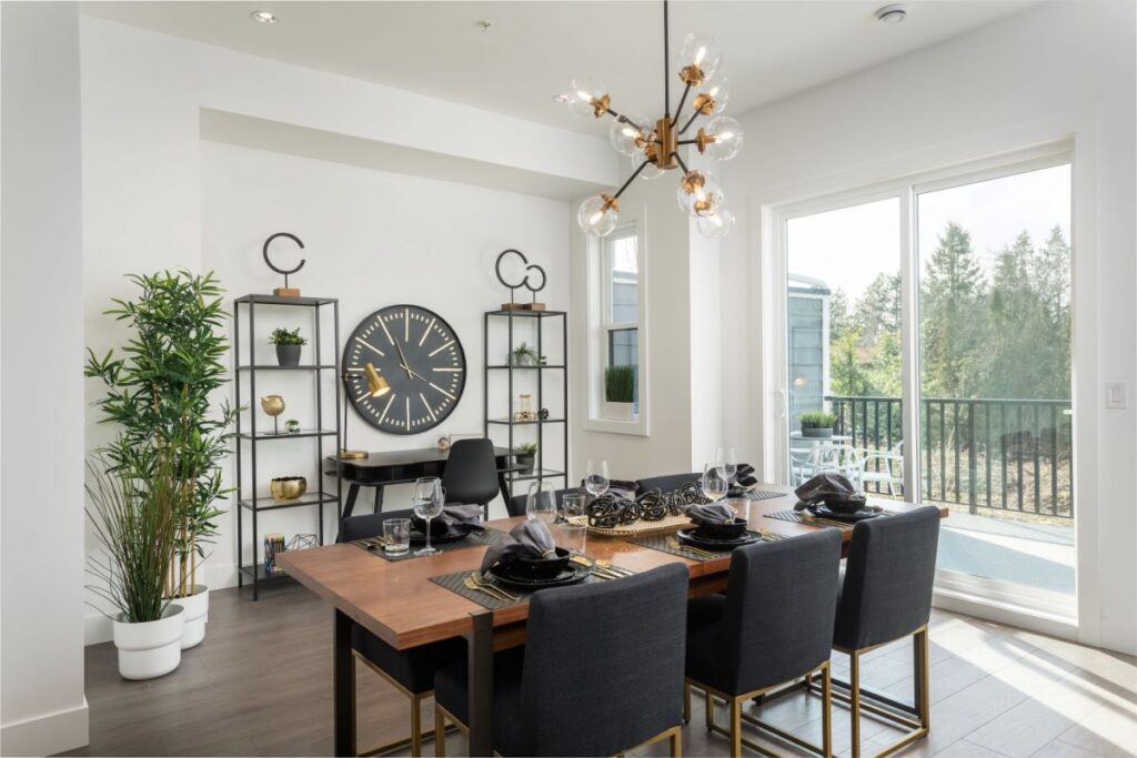 Unique dining room featuring rich black fabric chairs, wooden table, and copper fixtures.